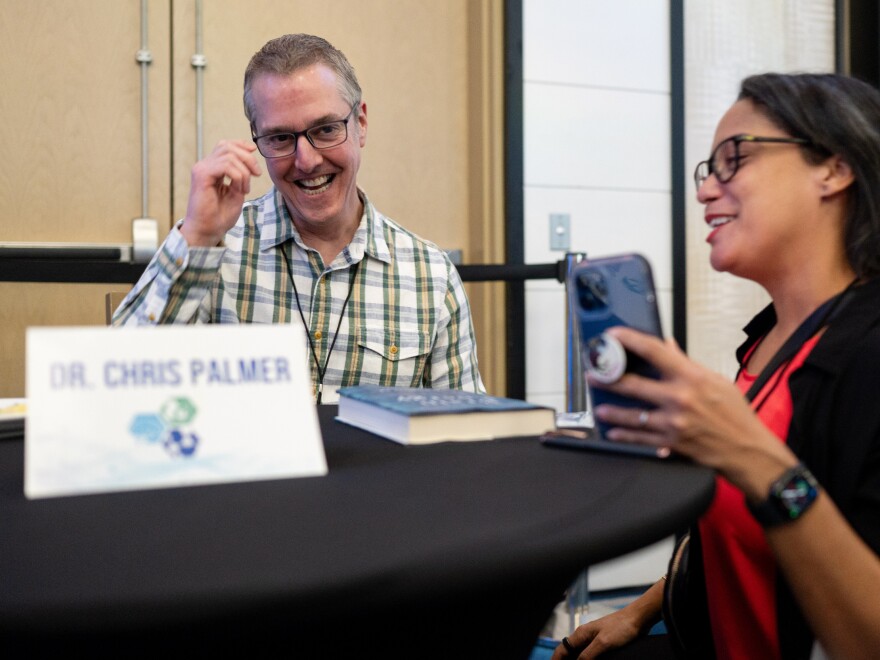 Dr. Chris Palmer (left) signs a copy of his book, <em>Brain Energy,</em> for Addanilka Ramos during the Metabolic Health Summit in Clearwater Fla. Palmer has been researching the keto diet for years.